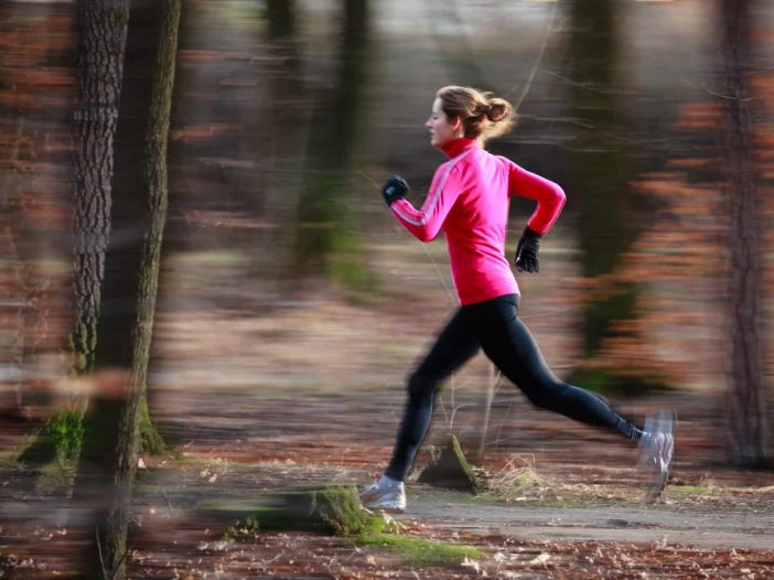 woman running outdoors | Prevent running injuries