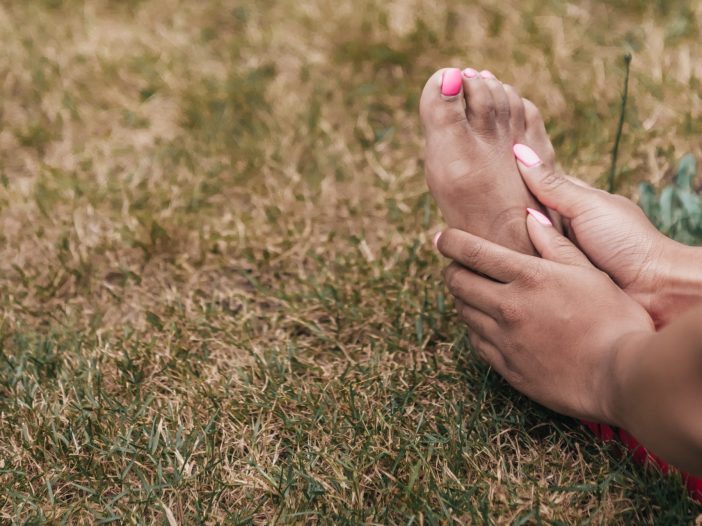 a close-up of someone caressing their feet, when are orthotics necessary
